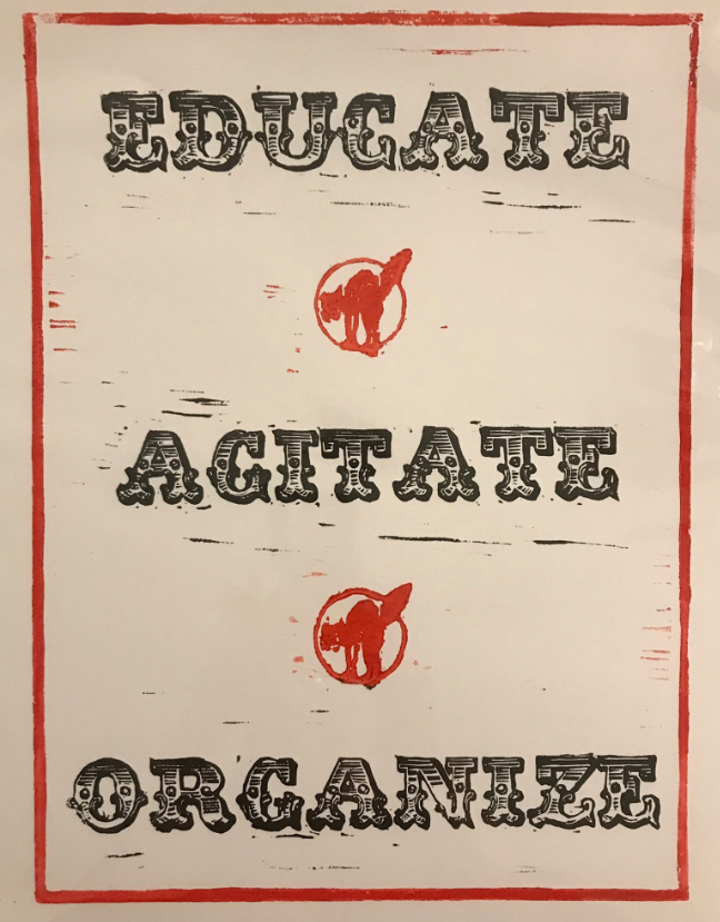 A printed poster with words 
EDUCATE
 AGITATE
ORGANIZE
bordered in red
2 circled stamps of agitated red cat inbetween words. Sepia/tan poster . Words in black block text, old font.
